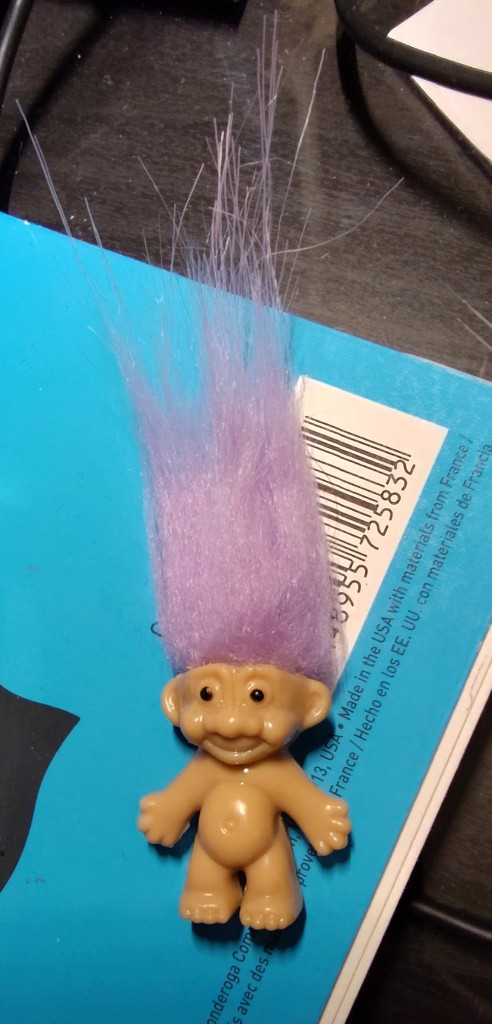 picture of a troll doll with purple hair